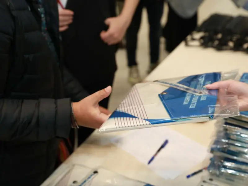 Delegate sets for an international forum: handmade textile folders and badges